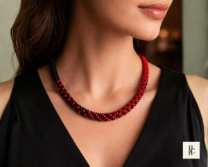 Model wearing handmade Crimson Noir Kumihimo beaded necklace with red and black glass seed beads, styled with black evening dress